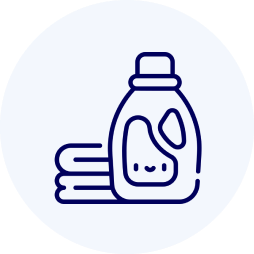 Icon of a laundry detergent bottle next to folded towels on a light gray background.